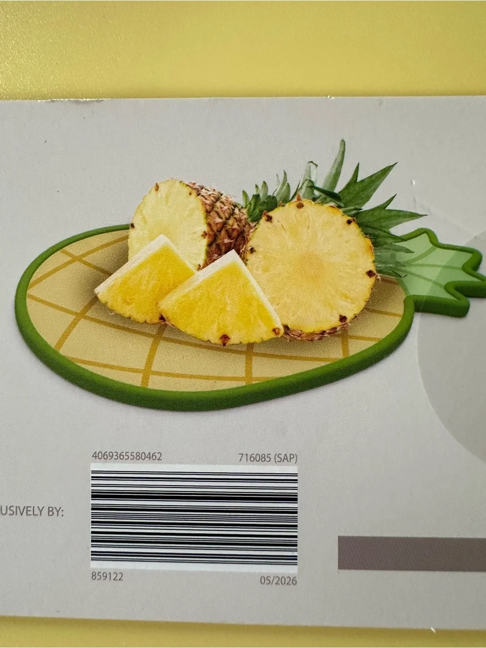 Croton Pineapple-Shaped Cutting Board in Yellow with Green Trim and Colander.